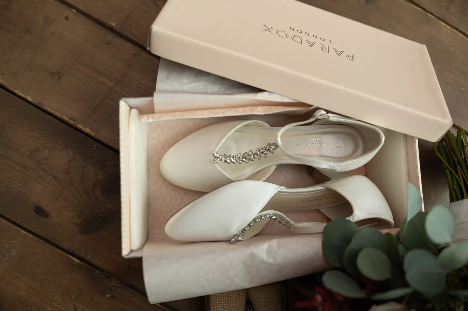 Ivory bridal shoes with jewelled straps in their box