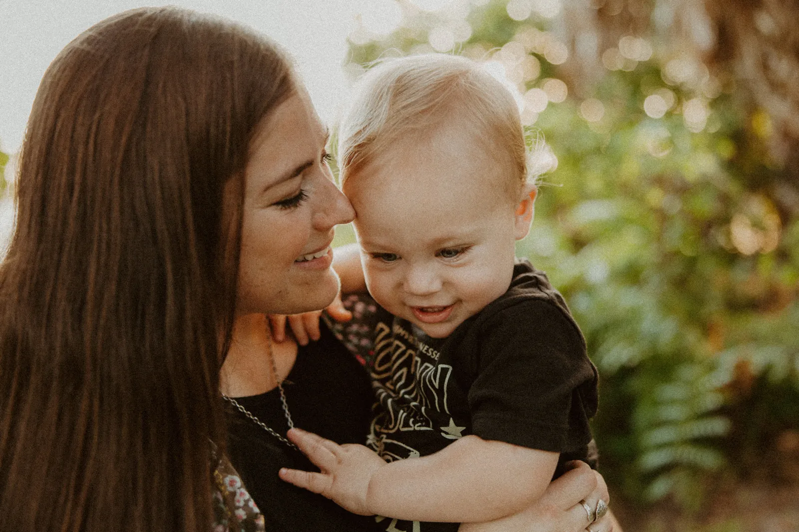 Mother nuzzling her toddler son