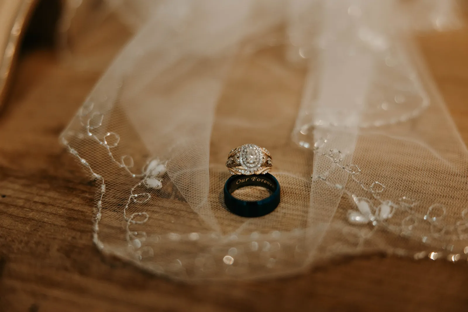 Wedding rings resting on a beaded veil