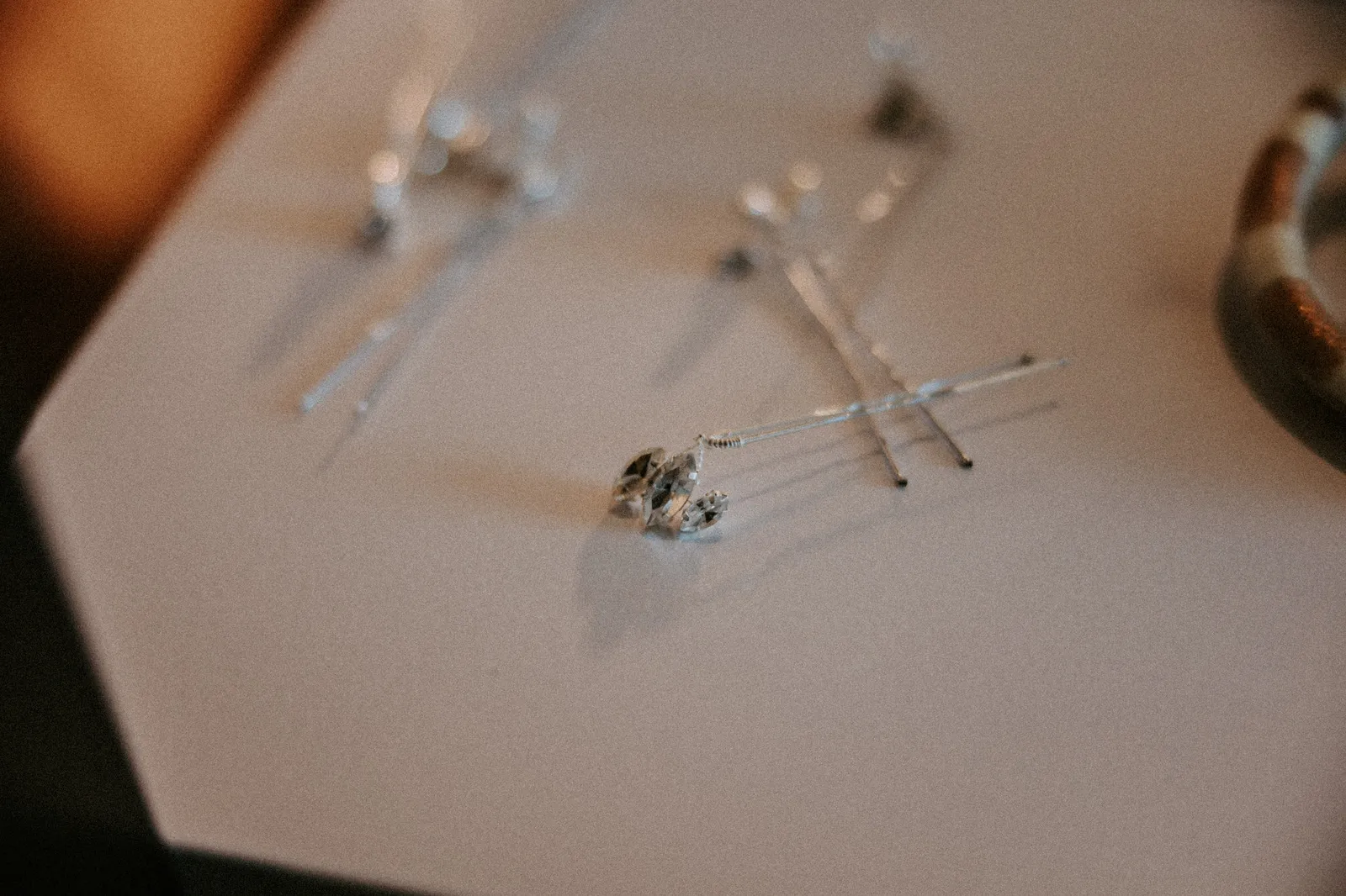 Hairpins and an earring on a white table