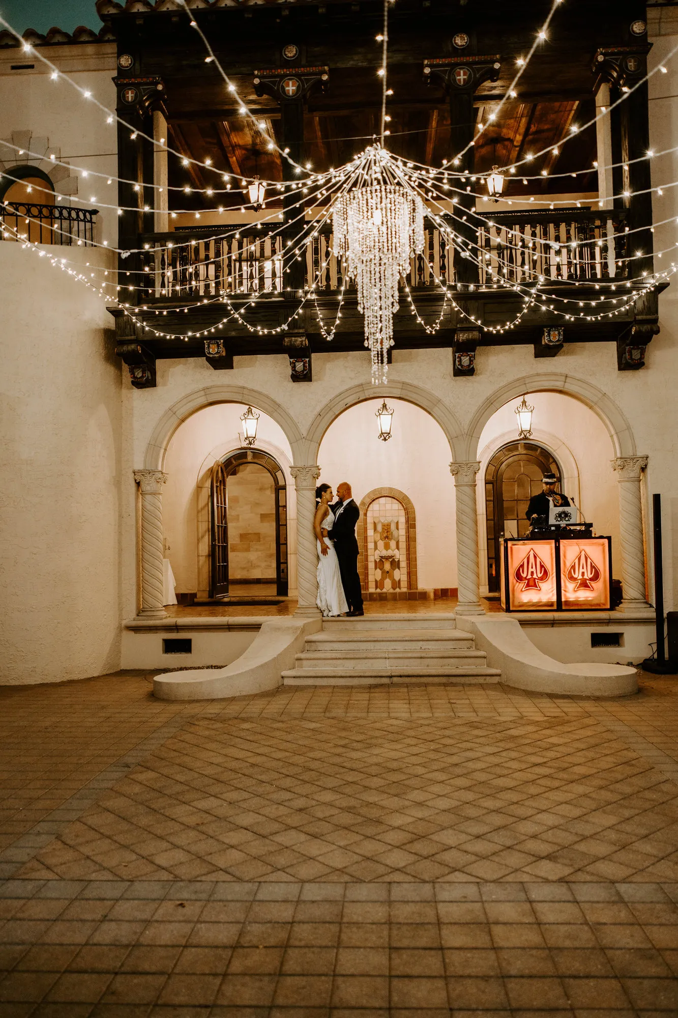 Powel Crosley Estate courtyard lit with string lights and a chandelier for the reception