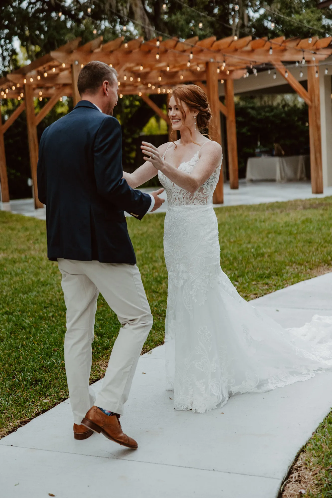 Bride and groom reaching for each other during their first look at Bakers Ranch