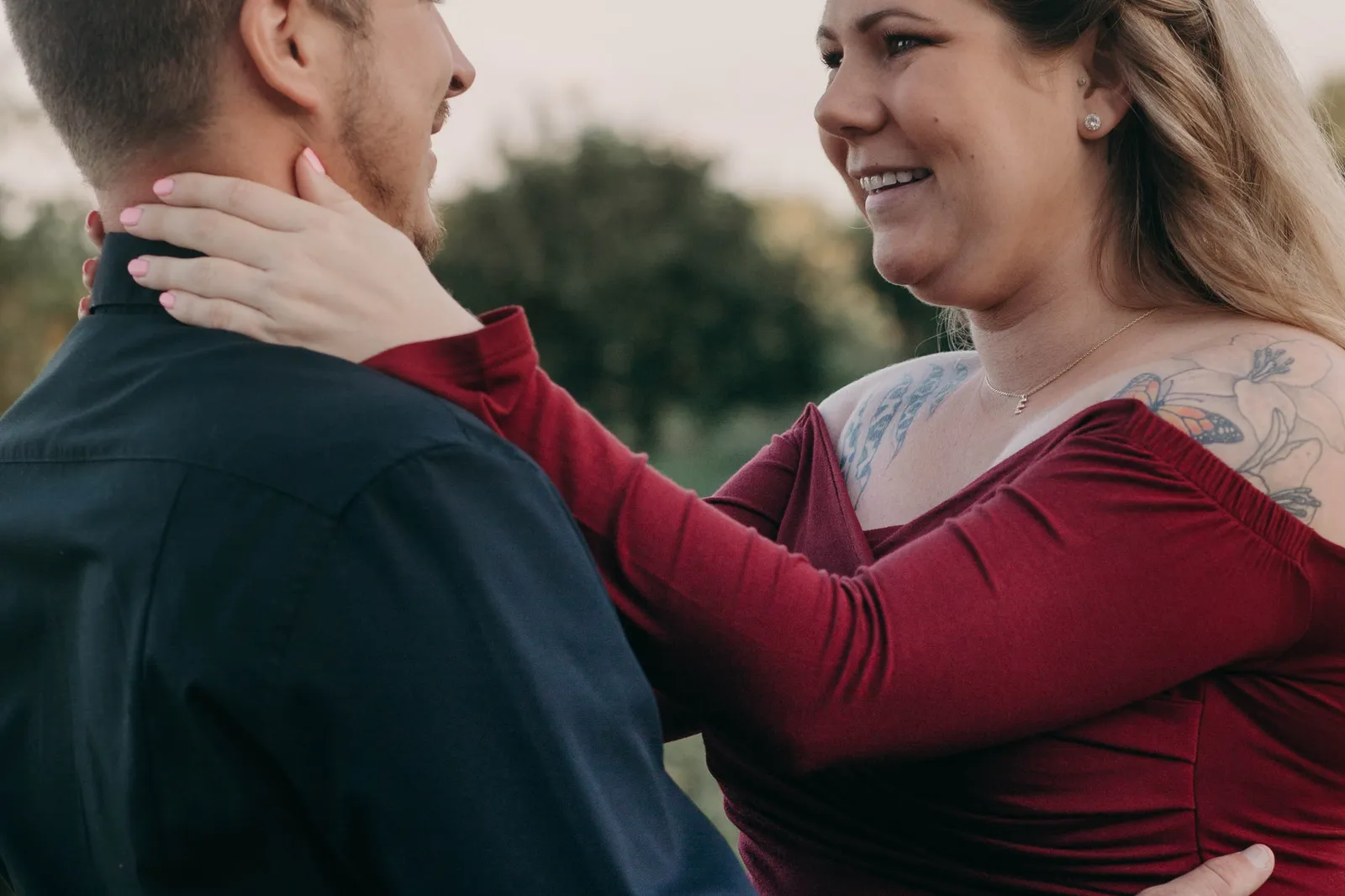 Woman smiling with her hand on the back of his neck