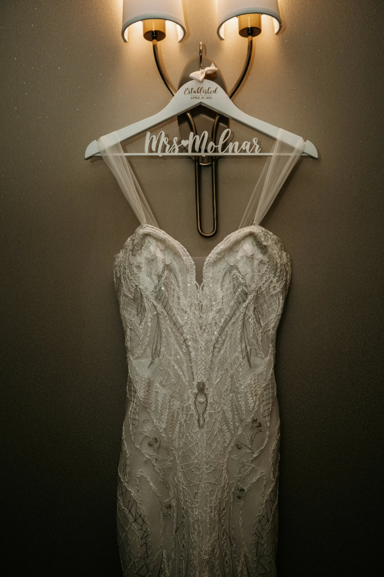 Beaded wedding dress hanging from a personalised hanger
