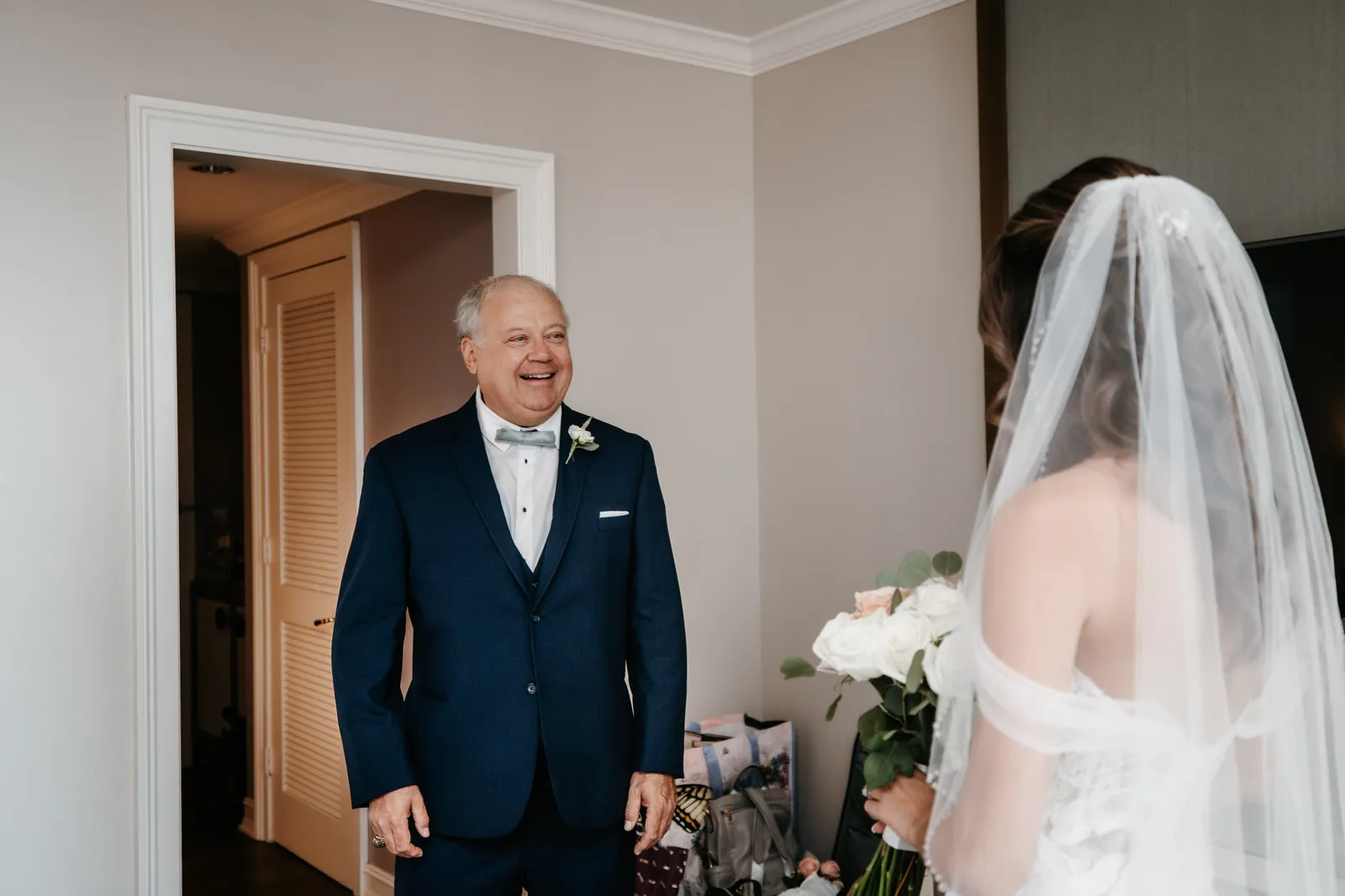 Bride's father seeing her in her wedding dress for the first time