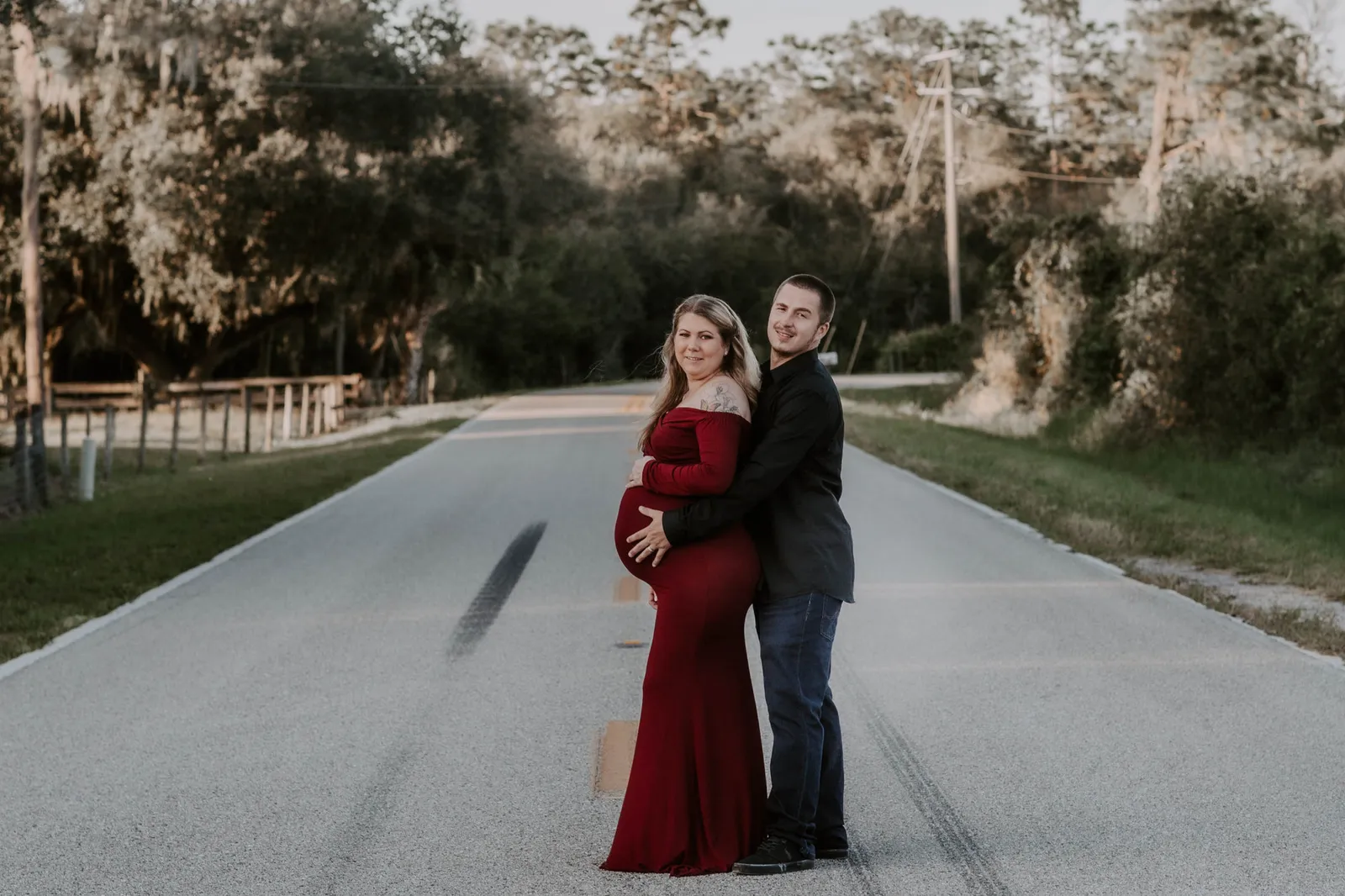 Couple embracing in the middle of a quiet country road