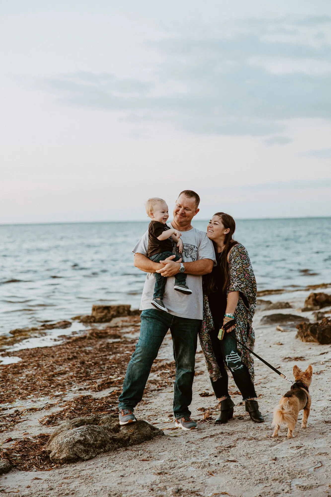 Family of three with their dog on the shore at Emerson Point Preserve