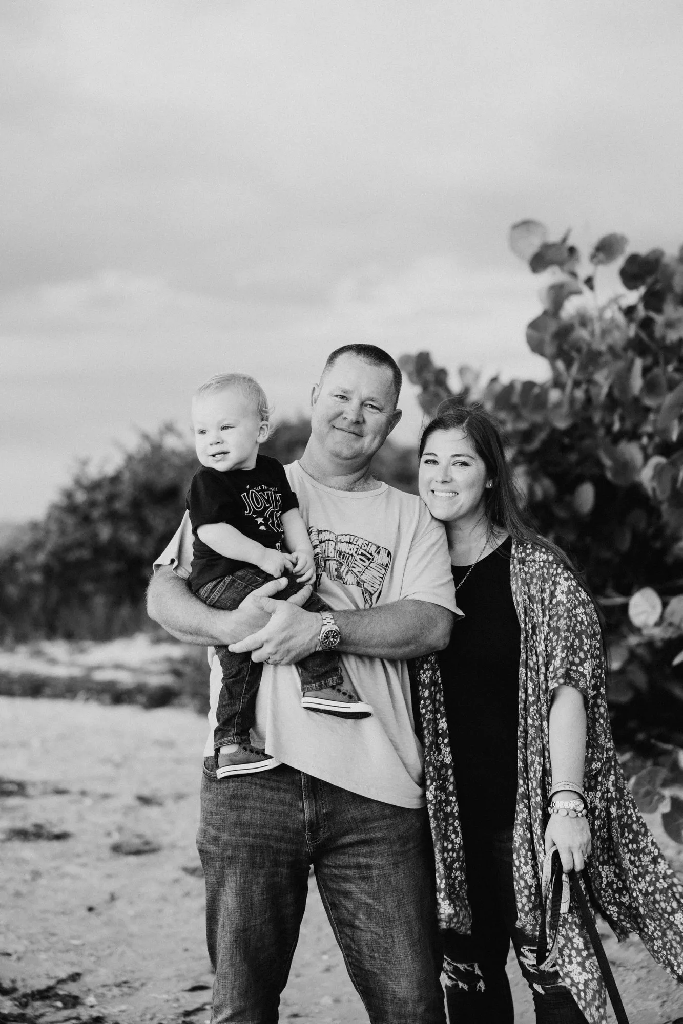 Family portrait in front of sea grape trees, in black and white
