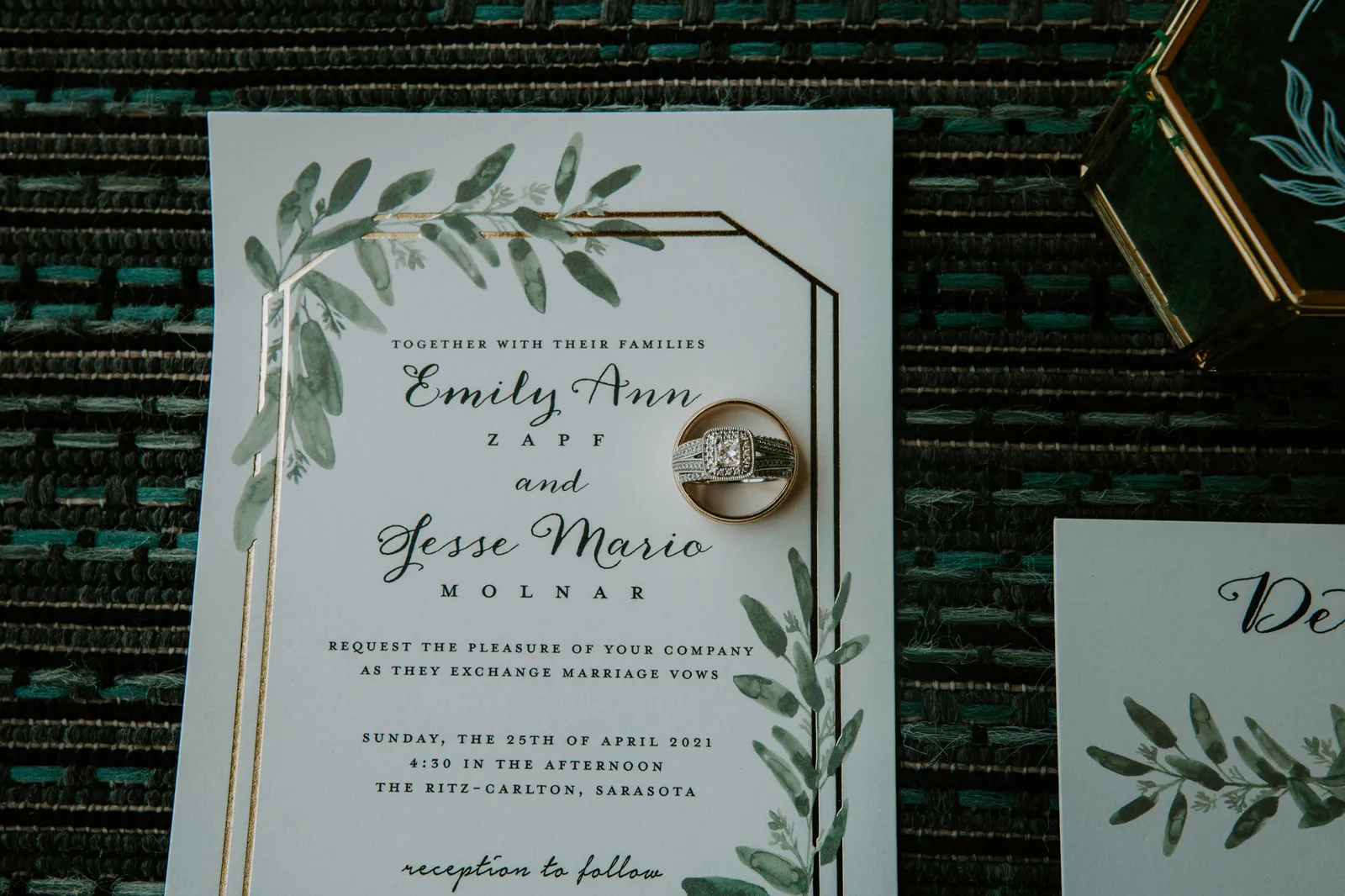 Wedding invitation with the rings resting on it