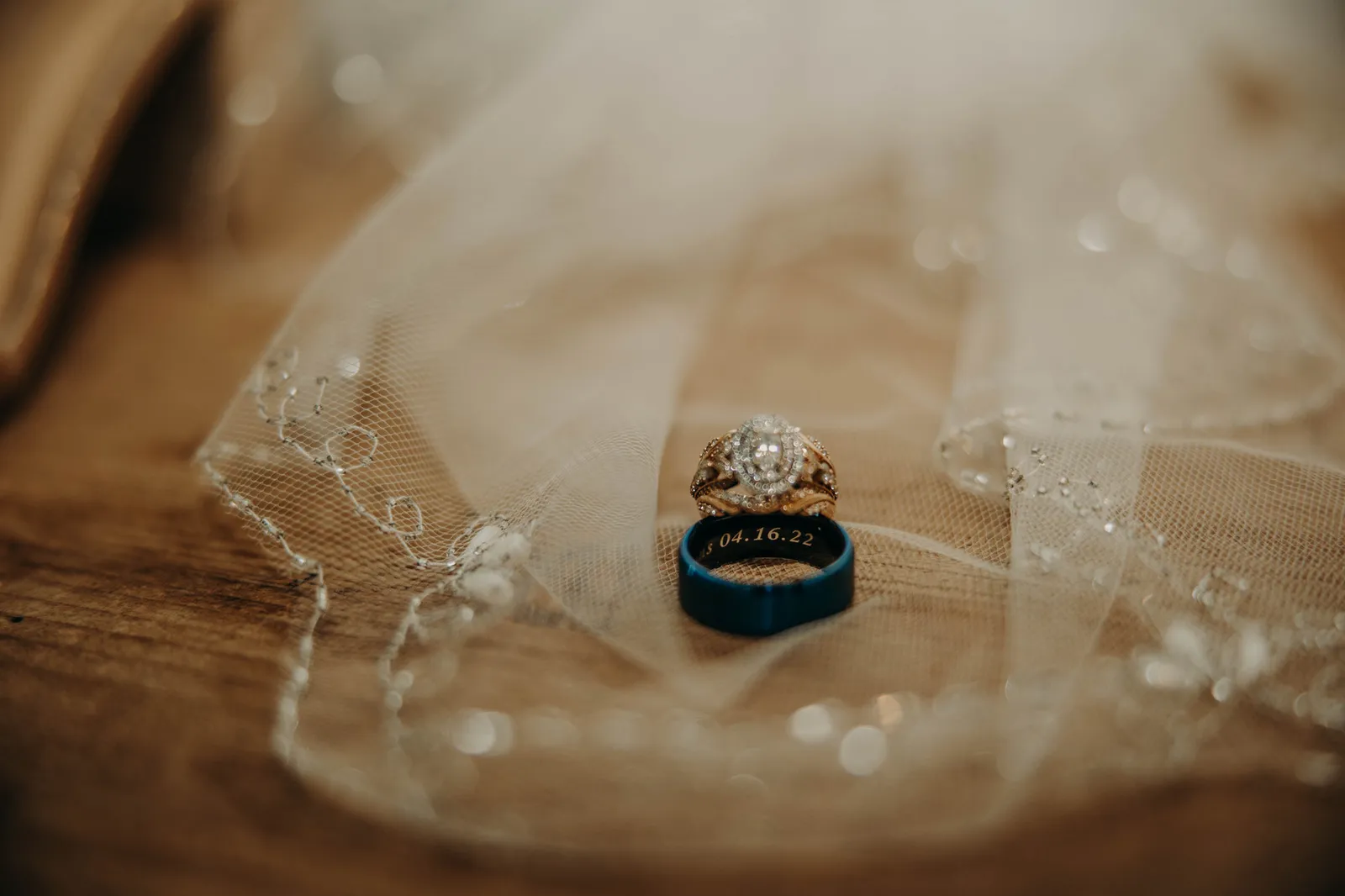 Engraved wedding band and diamond ring on the veil