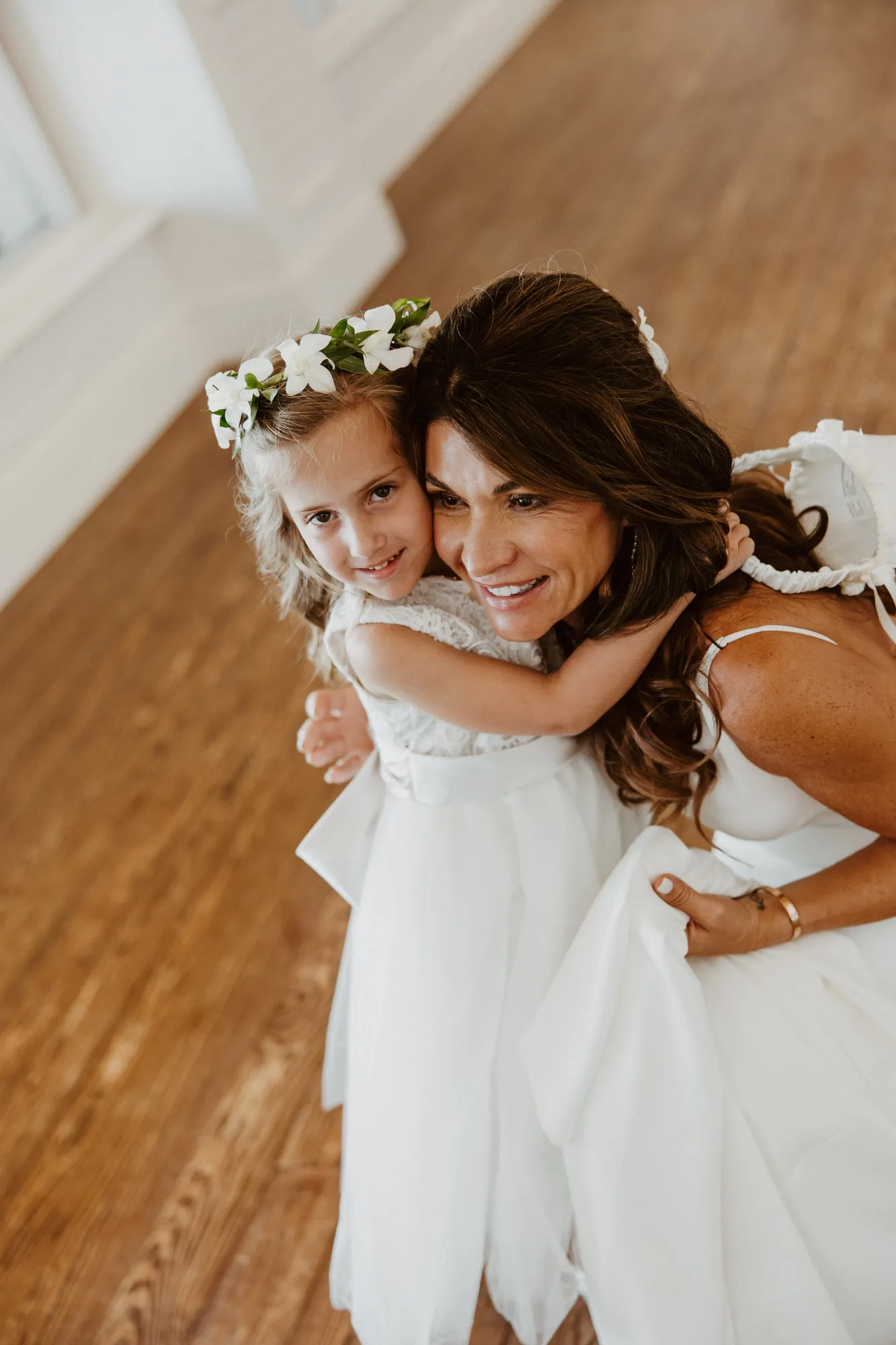 Bride hugging her flower girl at the Ritz-Carlton Beach Club