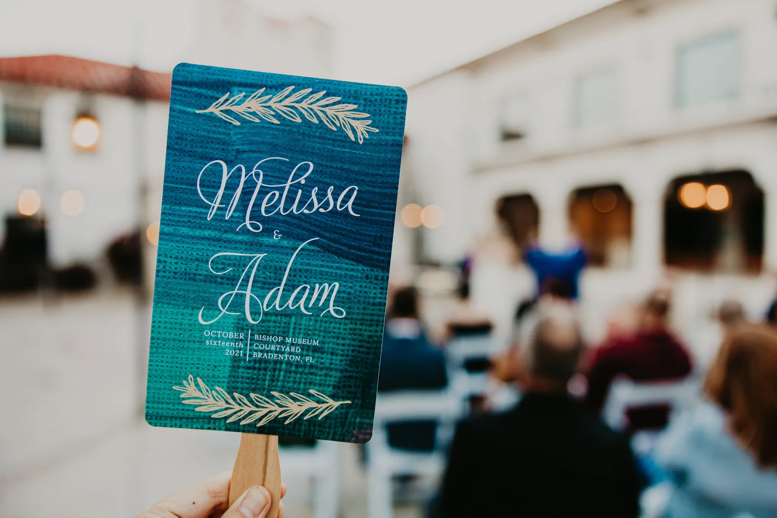 Ceremony program fan printed with the couple's names