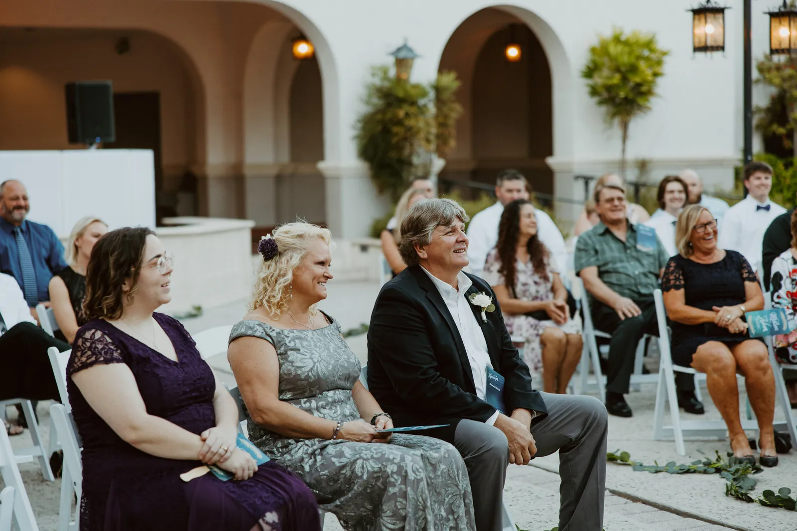 Seated guests smiling during the ceremony