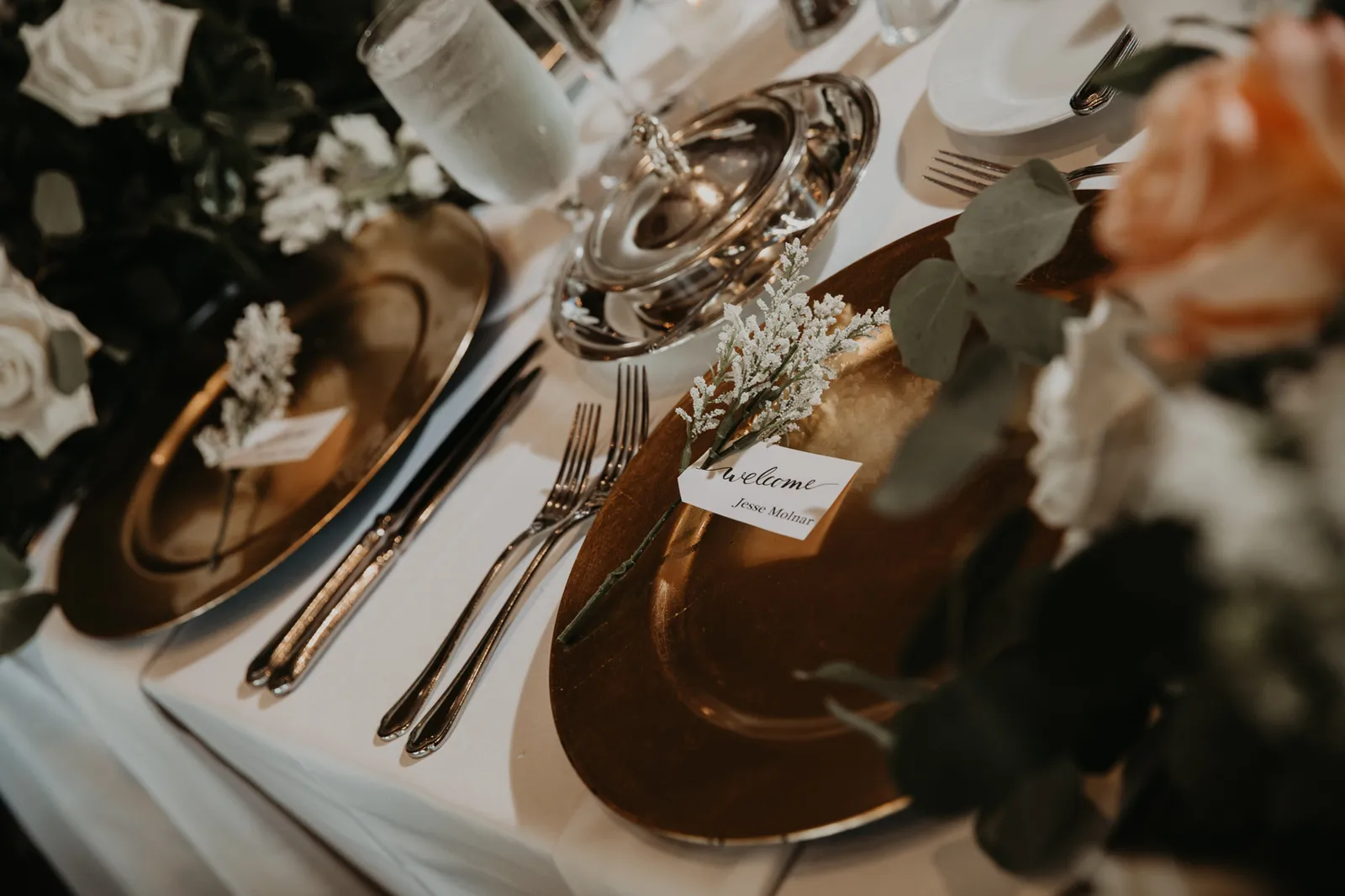 Reception place setting with gold chargers and name cards