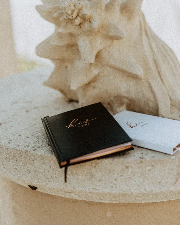 Two vow books resting on a stone pedestal