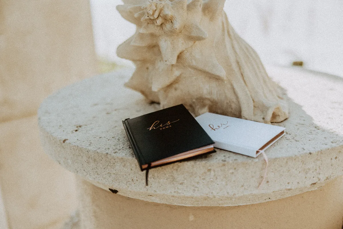 Two vow books resting on a stone pedestal